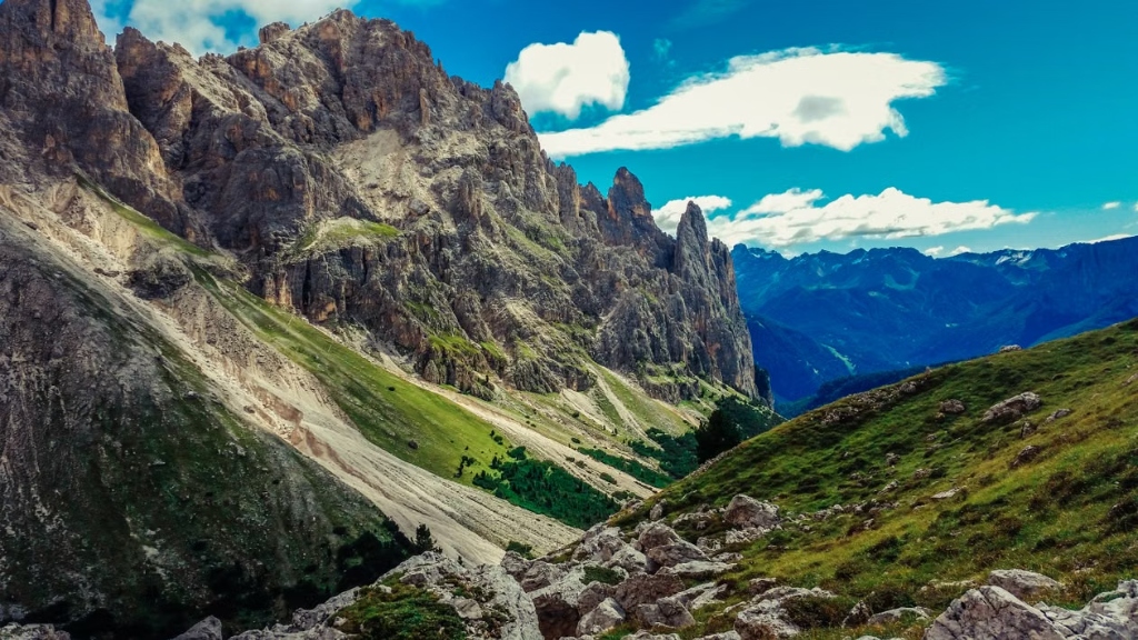 Breathtaking Dolomites mountain peaks with green slopes and a blue sky